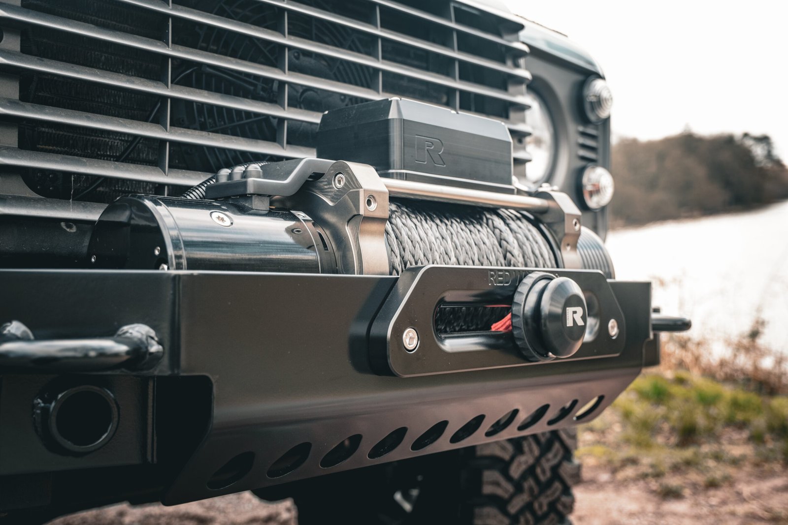 Gun Metal Land Rover Defender with a winch in Somerset woodland